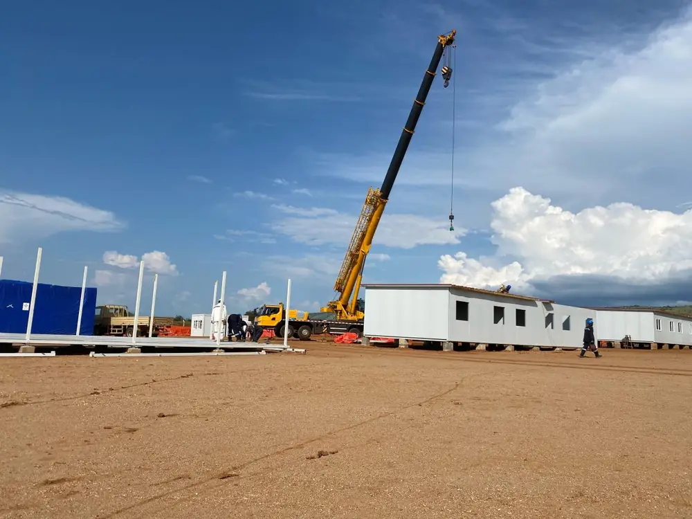 Modular site clinic being installed by crane at a project site